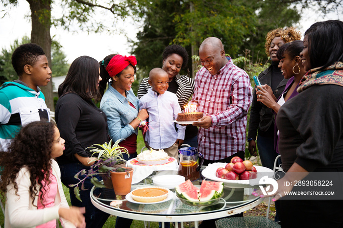 Multigenerational family celebrating birthday outdoors