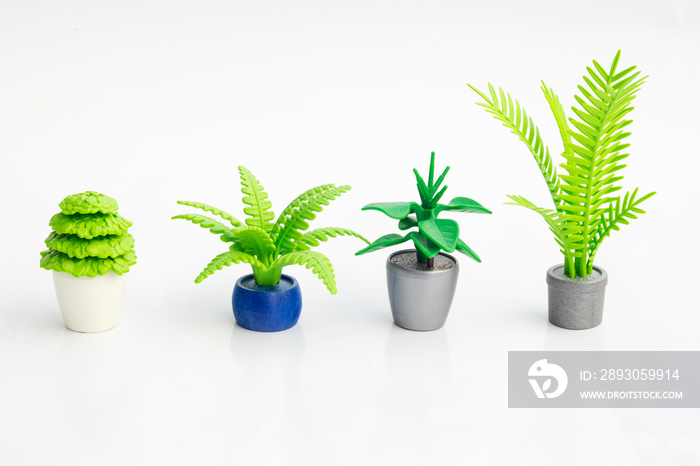 Detail of plastic toy plants in isolated white background