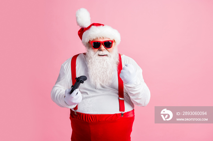 Portrait of his he nice cheerful cheery bearded fat guy Santa father playing console station contest
