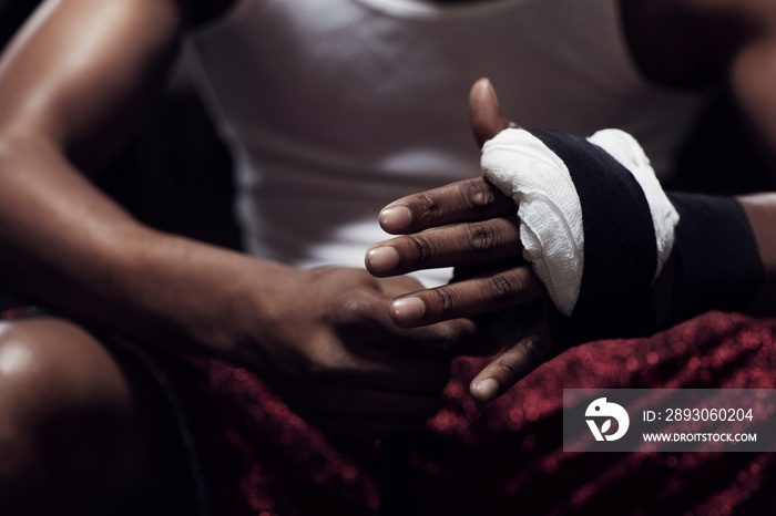 Man wrapping hands in gym