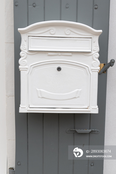 white home mailbox with grey wood background