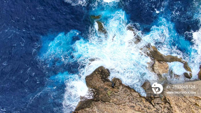 Wild Ocean water from above - Waves hitting the rocks - aerial photography