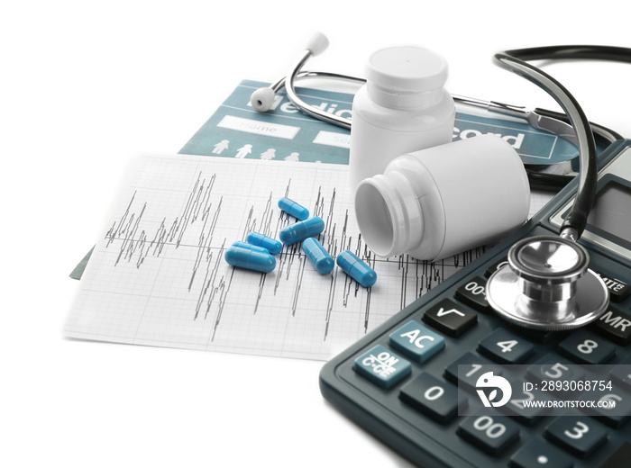 Medical concept. Medical record with pills,  calculator, and a stethoscope on white background