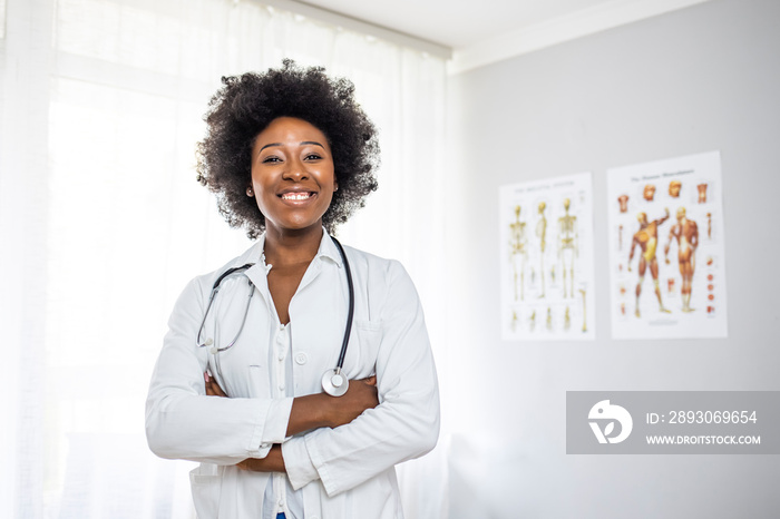 Portrait of female African American doctor standing in her office at clinic. Portrait of an attracti