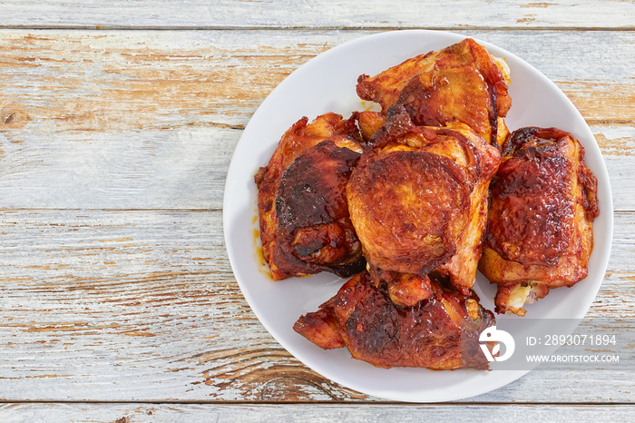 delicious fried chicken thigh on white plate, view from above