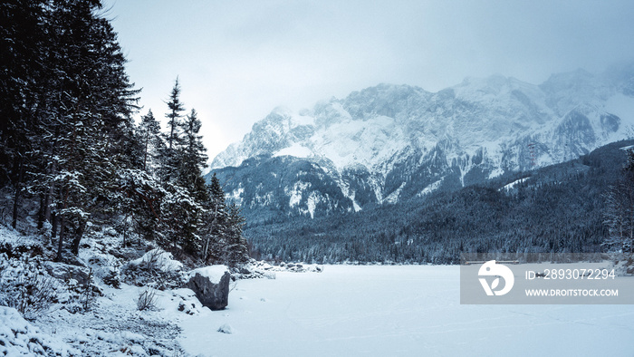 Wonderful landscape of the frozen lake Eibsee below Zugspitze mountain in winter