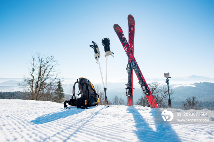 Shot of skiing equipment on top of the ski slope in the mountains winter sports skis backpack travel