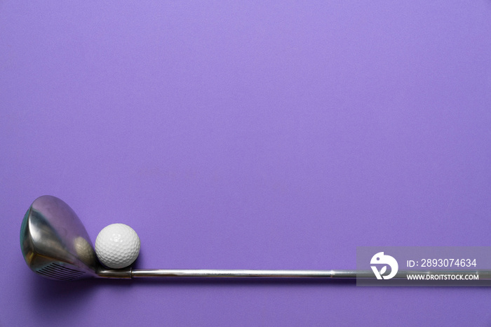 golf ball and golf club on purple background, sport concept