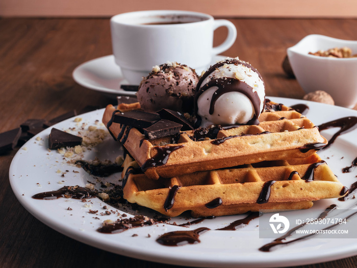 Belgian waffles with ice cream. Chocolate and nuts. wooden table. Rustik