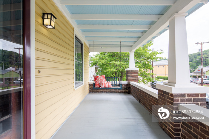 Bench Swing on front porch, Yellow walls and blue ceiling, front patio with swinging chair