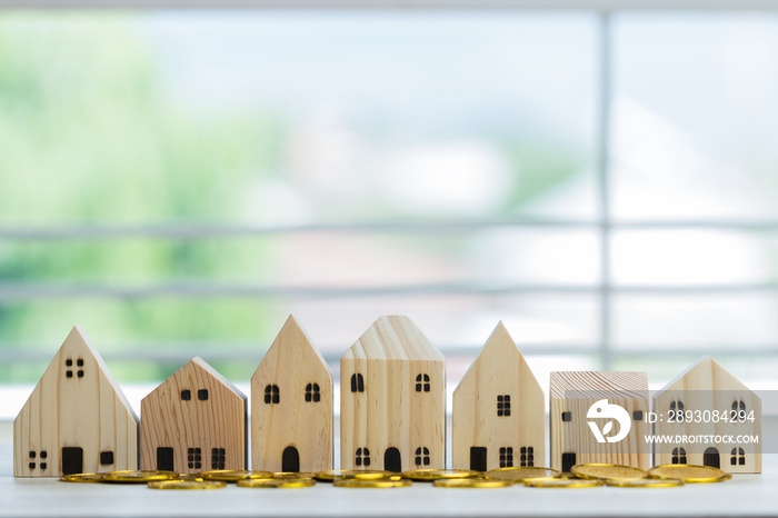 Home real estate mortgage concept : House Miniature model with stack money coins show for selling. I