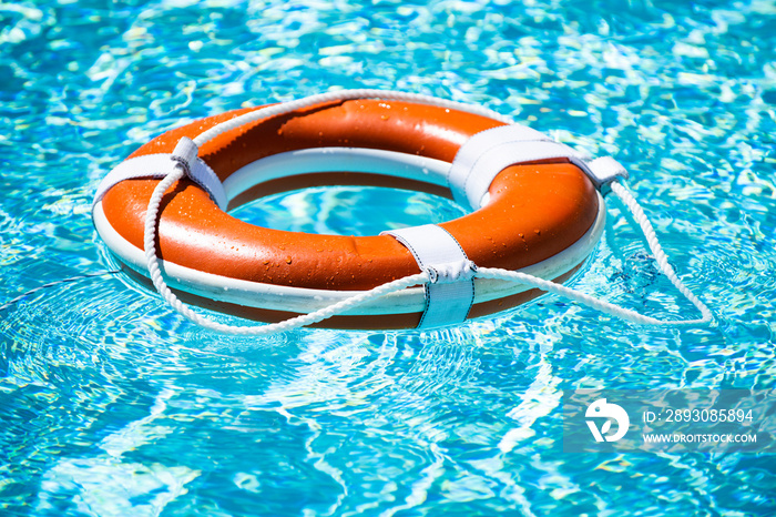 Lifebuoy pool ring float on blue water.