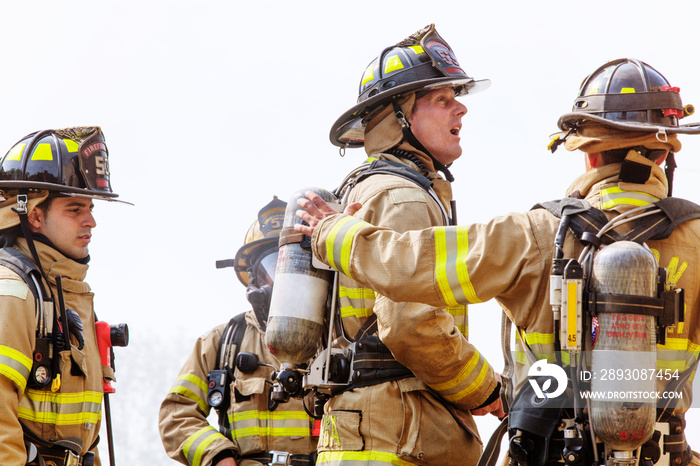 Firefighters standing against sky