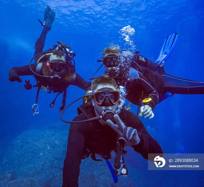 Group of divers taking a selfie photo. Blue water. Diving in Sardinia Italy. Underwater selfie