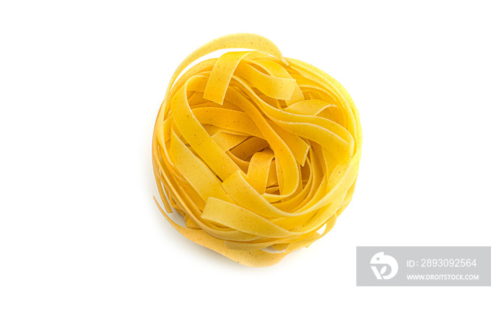 Uncooked fettuccine nest pasta on white background. High quality photo