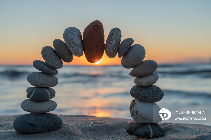 Stone arch at the beach at sunset