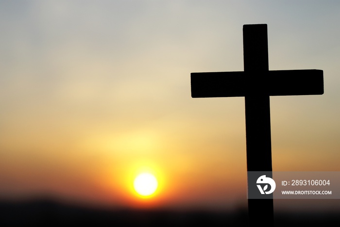 Silhouette of wooden cross on sky background