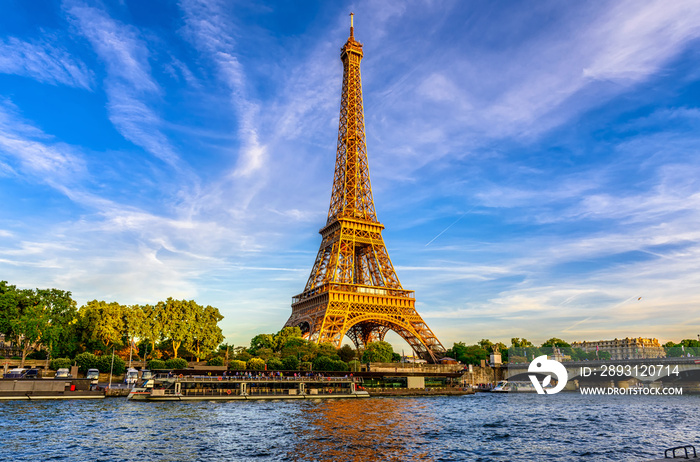 Paris Eiffel Tower and river Seine at sunset in Paris, France. Eiffel Tower is one of the most iconi