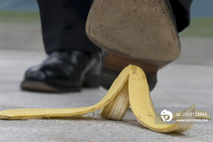 Businessman and banana skin