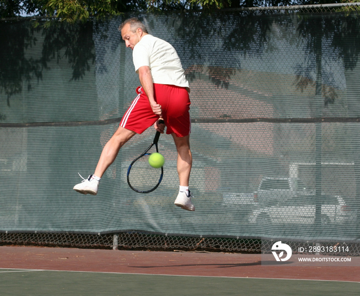 middleage man playing tennis