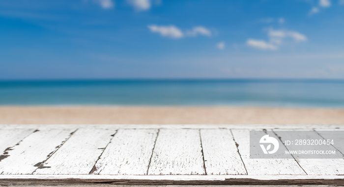 Wood table top and blurred summer blue sea and sky background. - can used for display or montage you