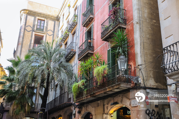 Beautiful spanish house with a balcony and plants. Barcelona city architecture. Authentic photo.