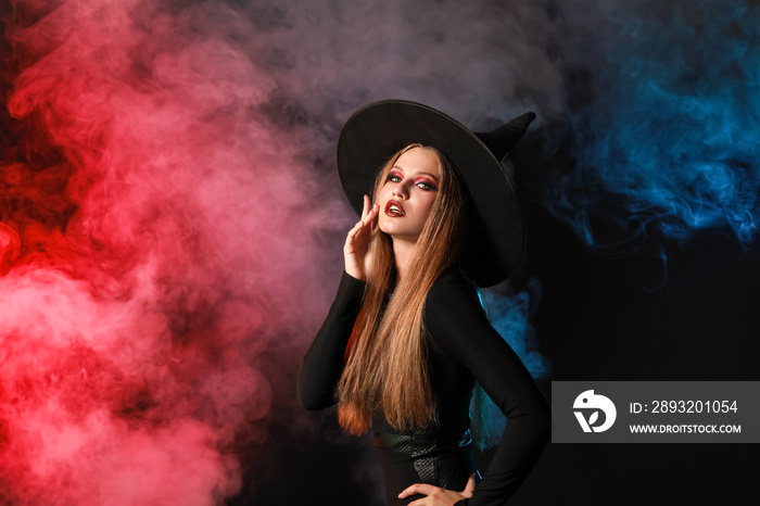 Beautiful woman dressed as witch for Halloween on dark background