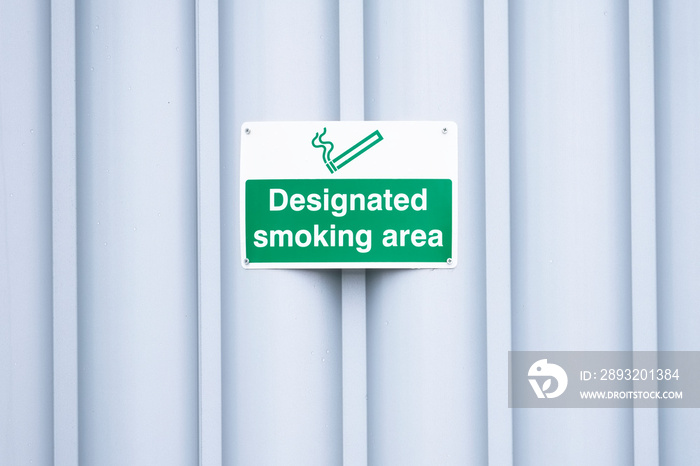 Designated smoking area sign outdoors at work place