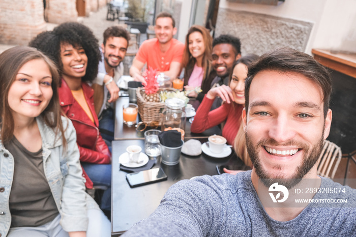 Group of happy friends drinking coffee and cappuccino at bar outdoor - Young millennials people taki