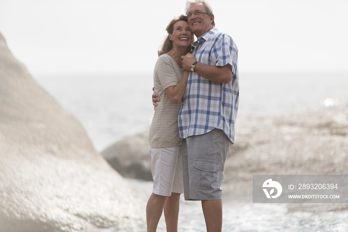 Happy affectionate senior couple on beach