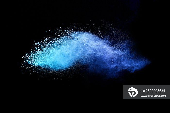 Abstract brown powder explosion. Closeup of blue dust particle splash isolated on black background.