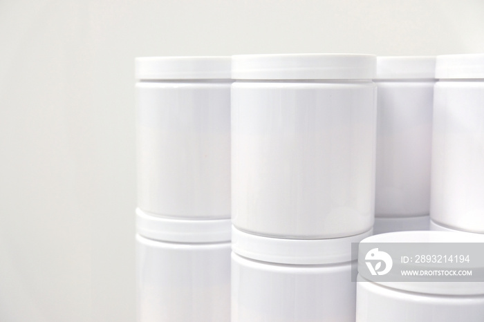 Blank white PET containers for supplement or beauty industry manufacturing mockup concept.