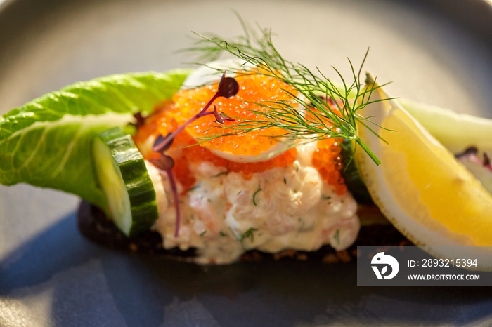 close up of toast skagen with caviar and bread