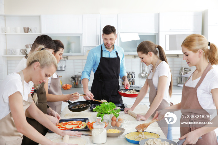 Male chef and group of people at cooking classes