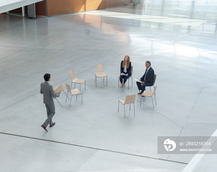 Businessman joining colleagues meeting in circle