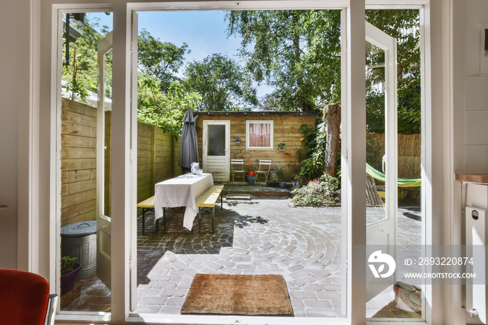 Open wooden white doors leading to the courtyard of the house