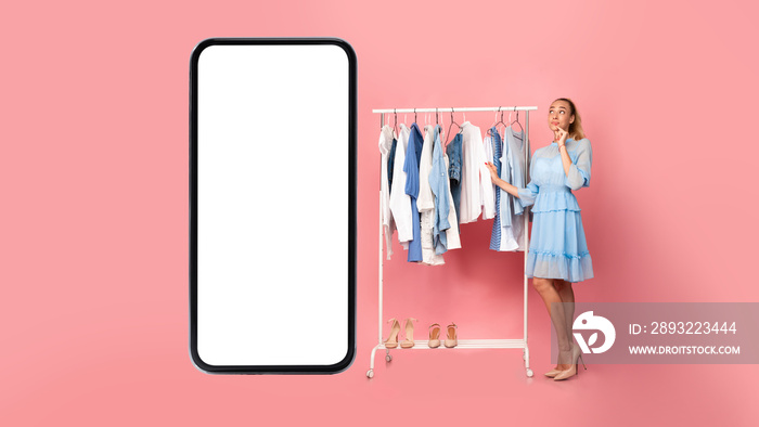 Woman Standing Near Cellphone Screen Shopping Online Choosing Clothes, Studio