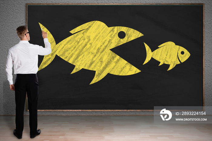 Businessman Drawing Sketch Of Big Fish Eating Small Fish