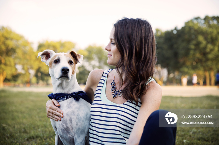 Woman with dog sitting outdoors