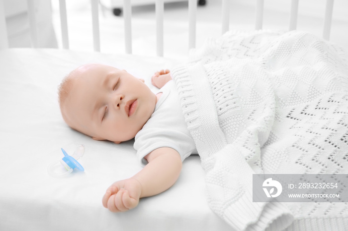 Adorable baby sleeping in cradle at home