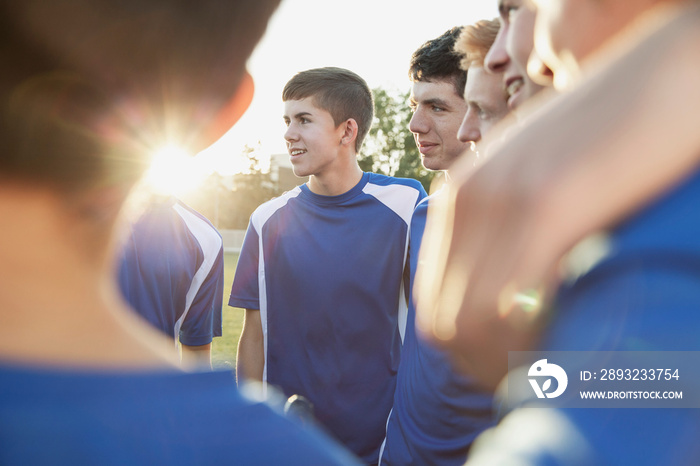 Soccer team huddled in conversation.