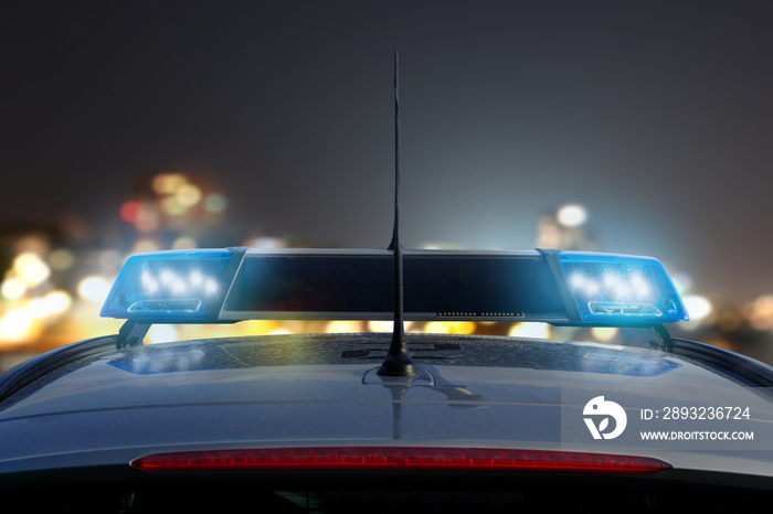 police car on the road at night