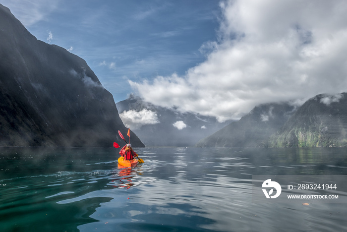 Two people kayaking in Milford Sound, New Zealand