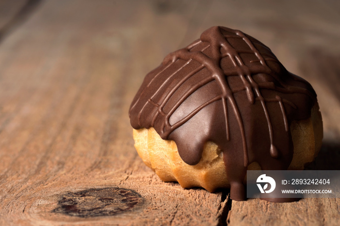 One open  traditional type of Brazilian profiterolis bakery candy called carolina in rustic wood bac