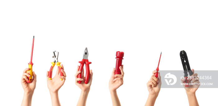 Female hands with electricians tools on white background