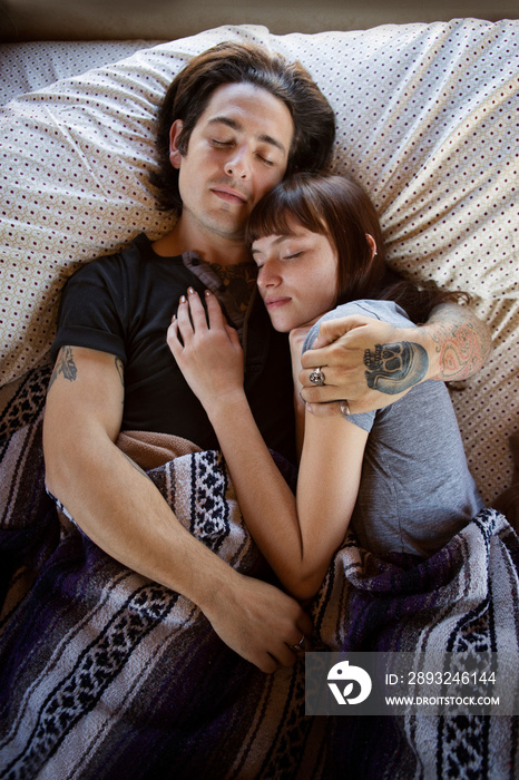 Young couple lying in bed