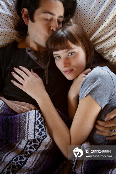 Overhead view of couple lying on bed