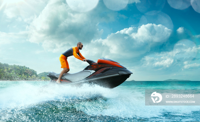 Young Man on water scooter, Tropical Ocean, Vacation Concept. Jet Ski. Sea.