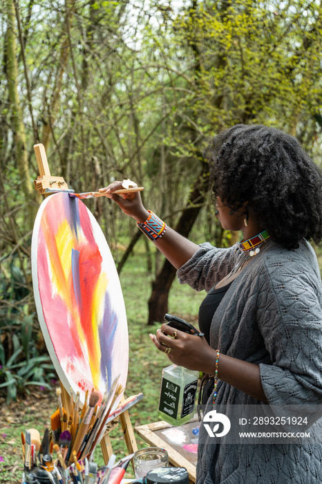 female painter with water spray bottle in hand