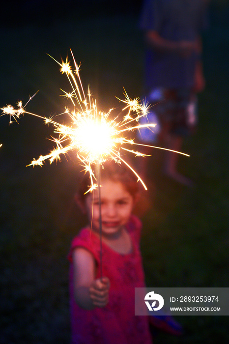 Little girl (4-5) holding sparkler